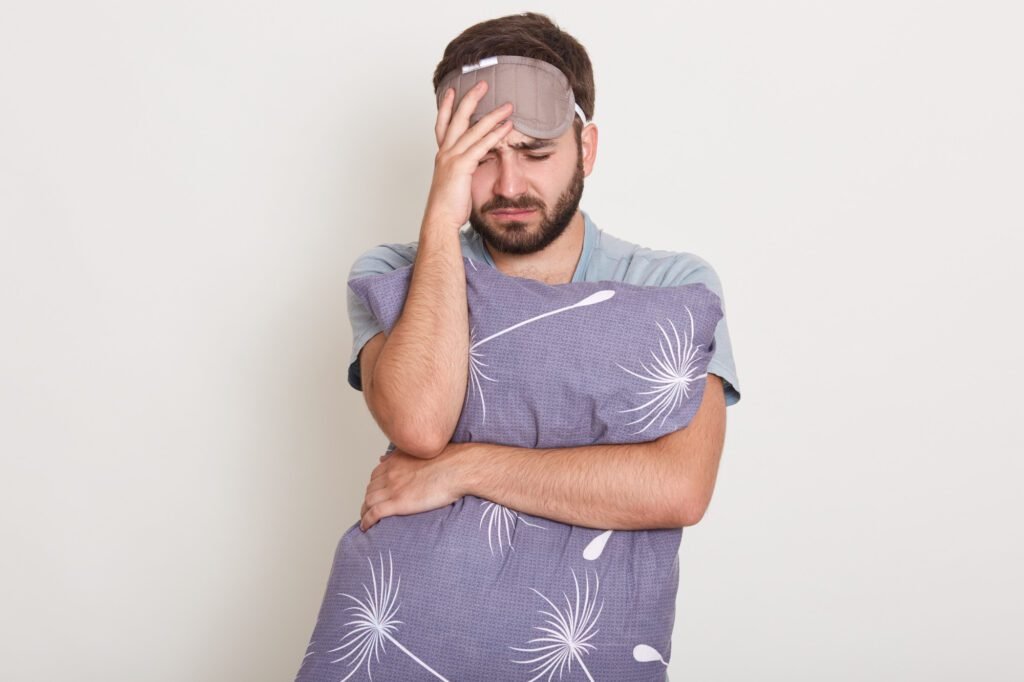 What are the Symptoms and Causes of Insomnia? 3 photo good looking caucasian man posing isolated white experiencing pain looks miserable exhausted